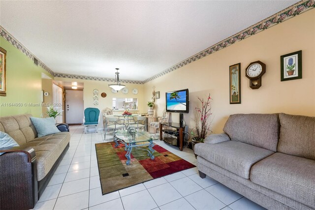 living room with a textured ceiling and light tile patterned floors