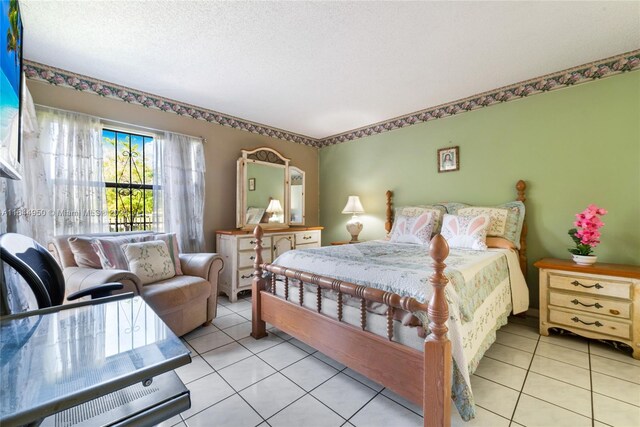 tiled bedroom featuring a textured ceiling