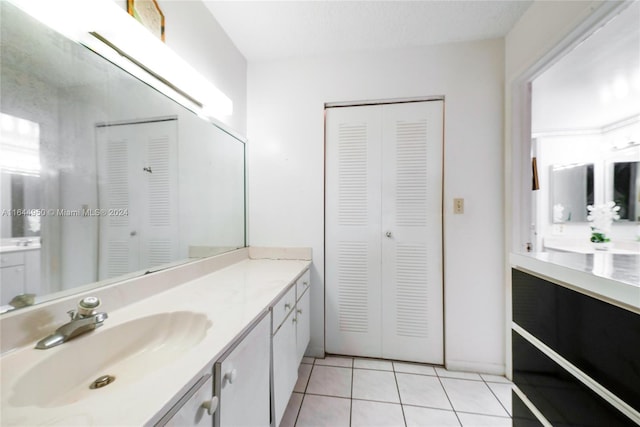 bathroom with tile patterned flooring and vanity