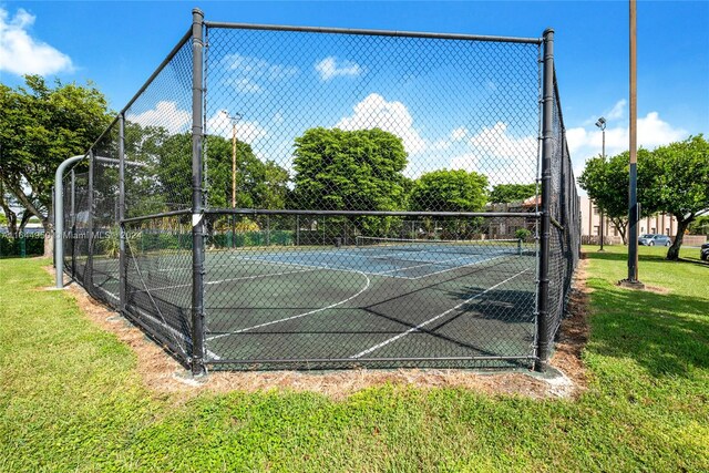 view of basketball court featuring tennis court and a yard