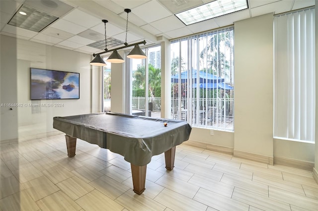 recreation room featuring billiards, plenty of natural light, and a paneled ceiling