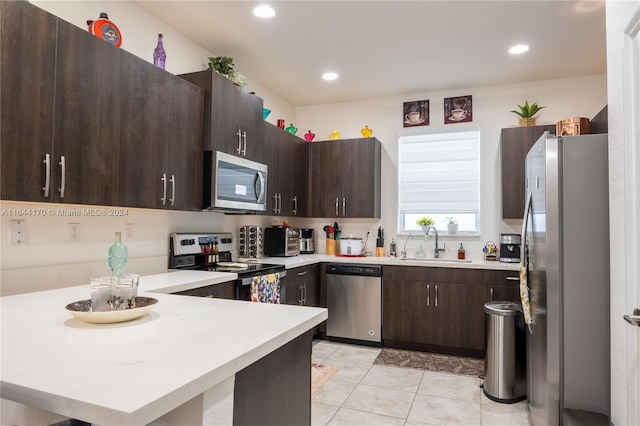 kitchen featuring dark brown cabinets, sink, and appliances with stainless steel finishes