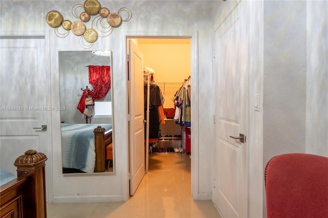 hall featuring light tile patterned floors