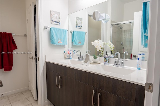 bathroom with tile patterned flooring, vanity, and a shower with door