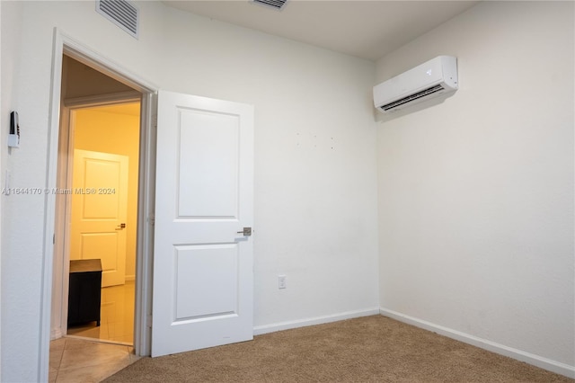 carpeted empty room with an AC wall unit