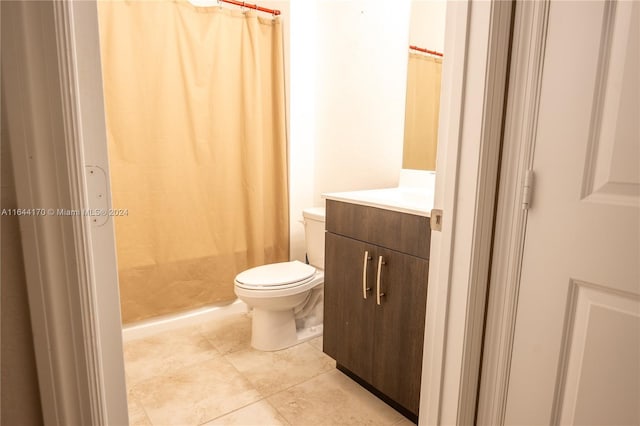 bathroom with tile patterned flooring, vanity, and toilet