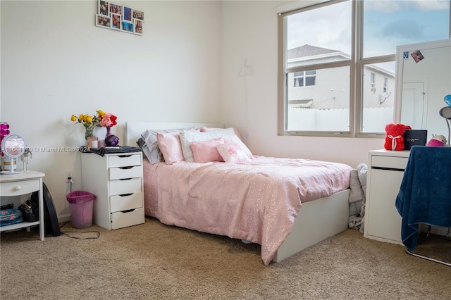 bedroom featuring light carpet