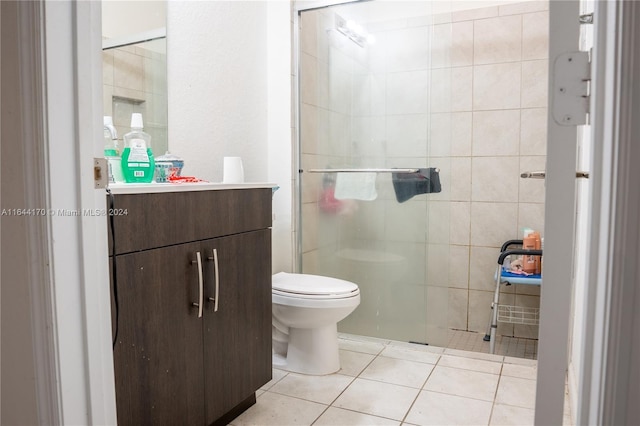 bathroom featuring walk in shower, tile patterned flooring, vanity, and toilet