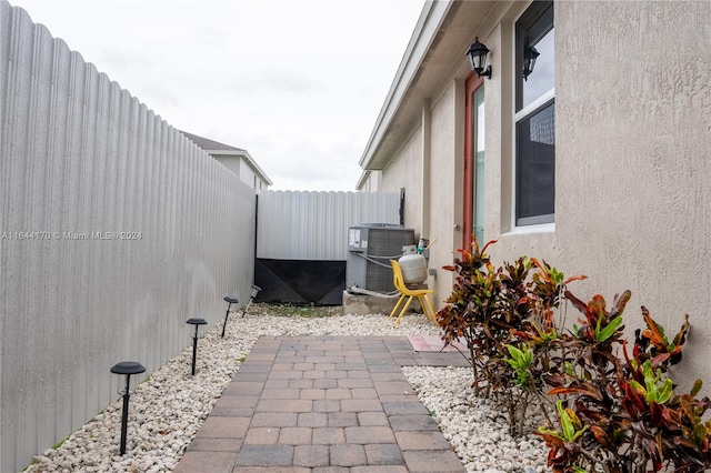 view of property exterior featuring a patio area and central air condition unit