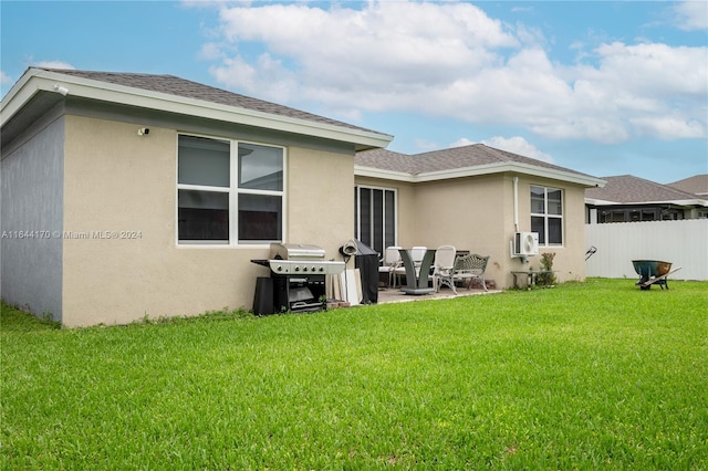 back of house with a yard and a patio