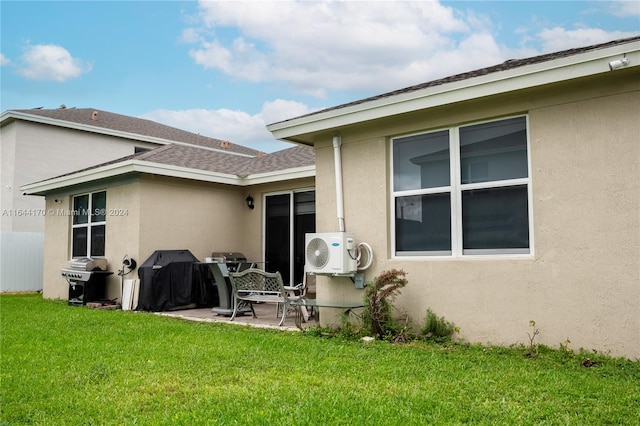 back of house with a lawn, ac unit, and a patio