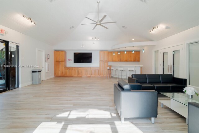 living room with high vaulted ceiling, ceiling fan, rail lighting, and french doors