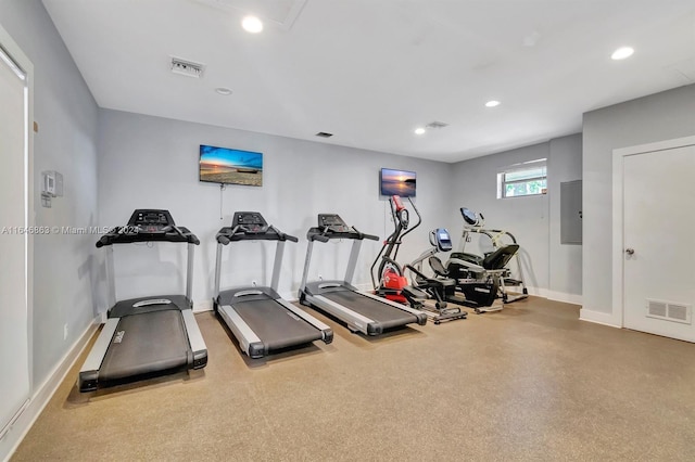 gym with recessed lighting, electric panel, visible vents, and baseboards