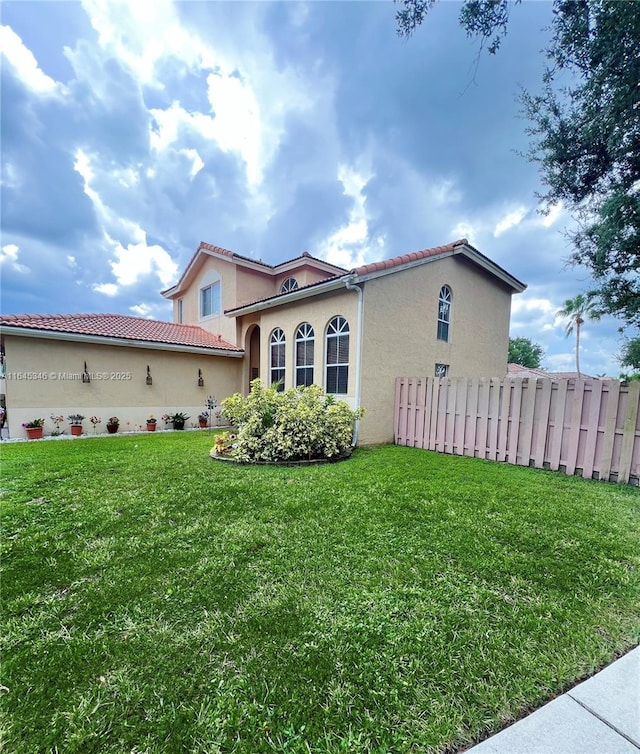 view of side of home with a yard