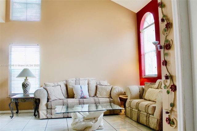 living room with lofted ceiling and light tile patterned floors