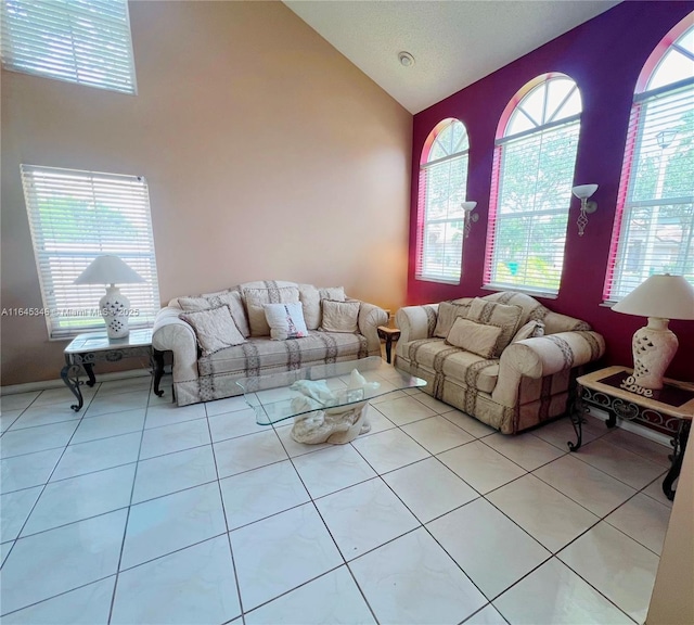 tiled living room featuring vaulted ceiling