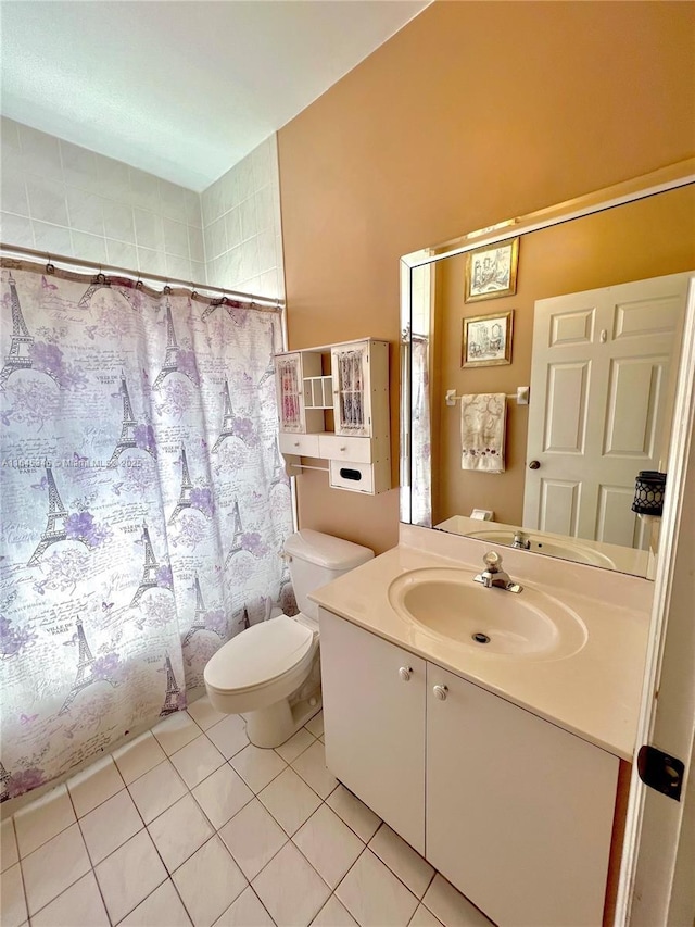 bathroom featuring tile patterned floors, a shower with curtain, vanity, and toilet