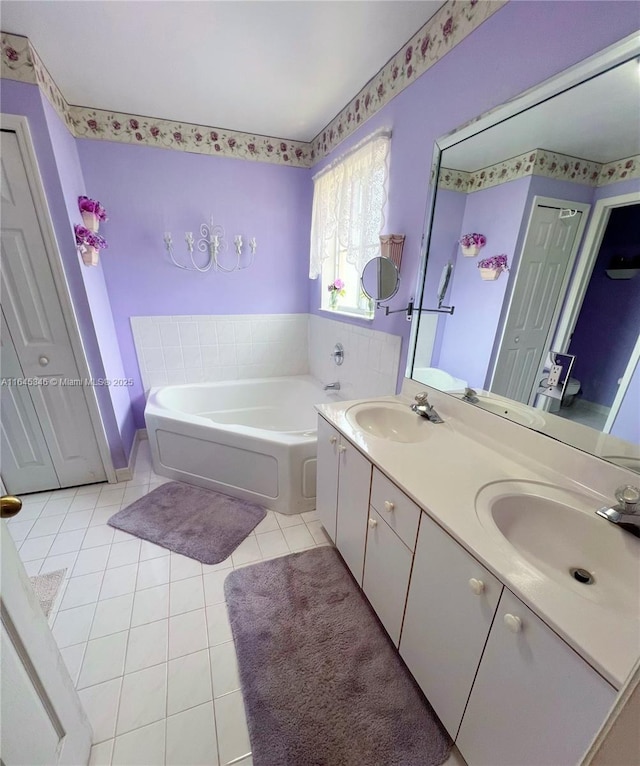 bathroom featuring tile patterned floors, a bathing tub, and vanity