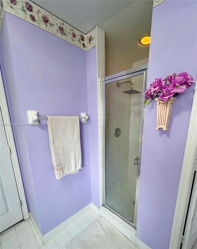 bathroom featuring tile patterned floors and a shower with shower door