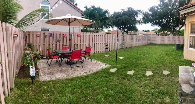 view of yard with central air condition unit and a patio area