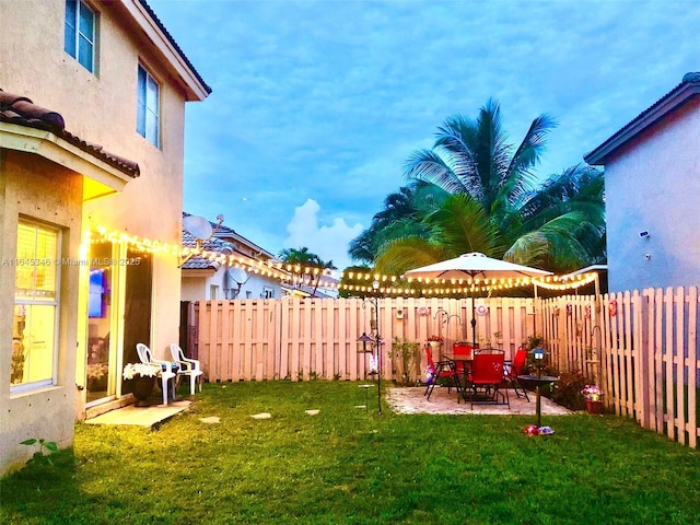 yard at dusk with a patio