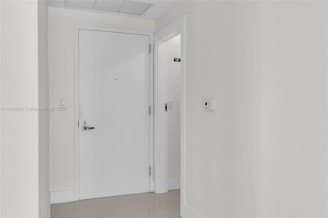 hall featuring light tile patterned flooring