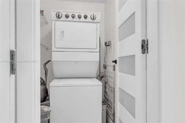 clothes washing area featuring laundry area and stacked washer / drying machine