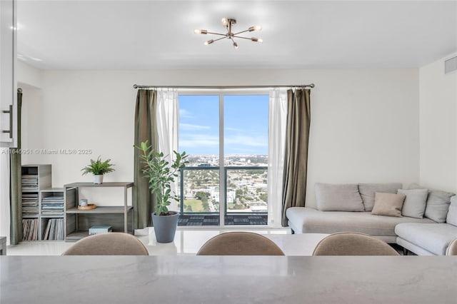 living room featuring visible vents and an inviting chandelier