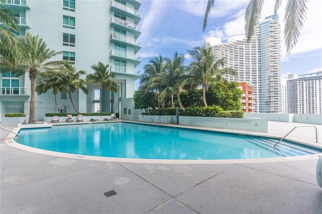 community pool with a patio area