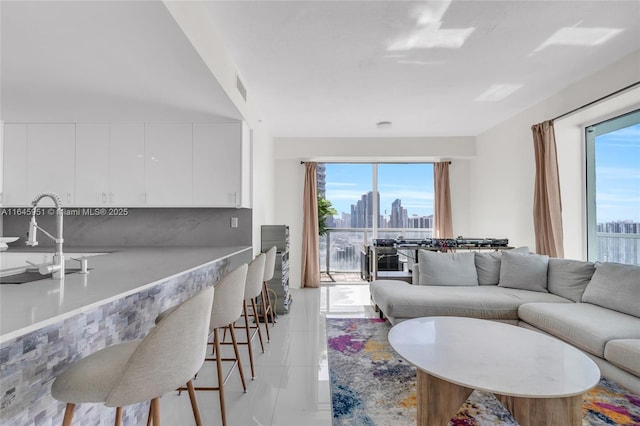 living room with a city view, a healthy amount of sunlight, and visible vents