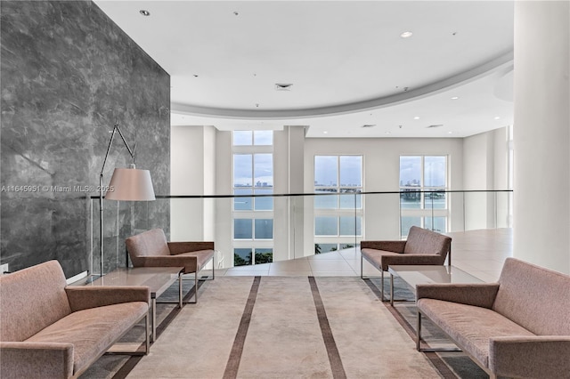 lobby featuring a water view and visible vents