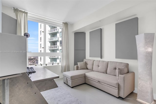 living room featuring a wealth of natural light and floor to ceiling windows