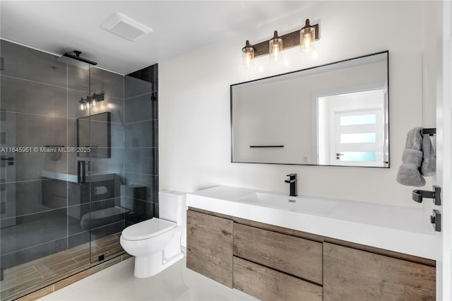 bathroom featuring toilet, a stall shower, and vanity