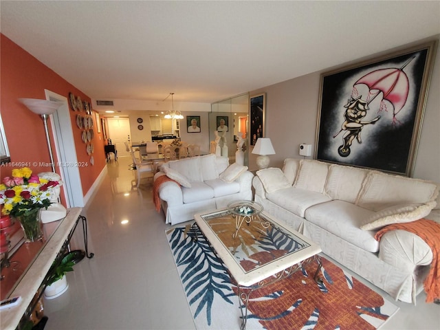 living room featuring a notable chandelier and tile patterned floors