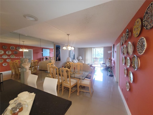 dining area with an inviting chandelier and concrete flooring