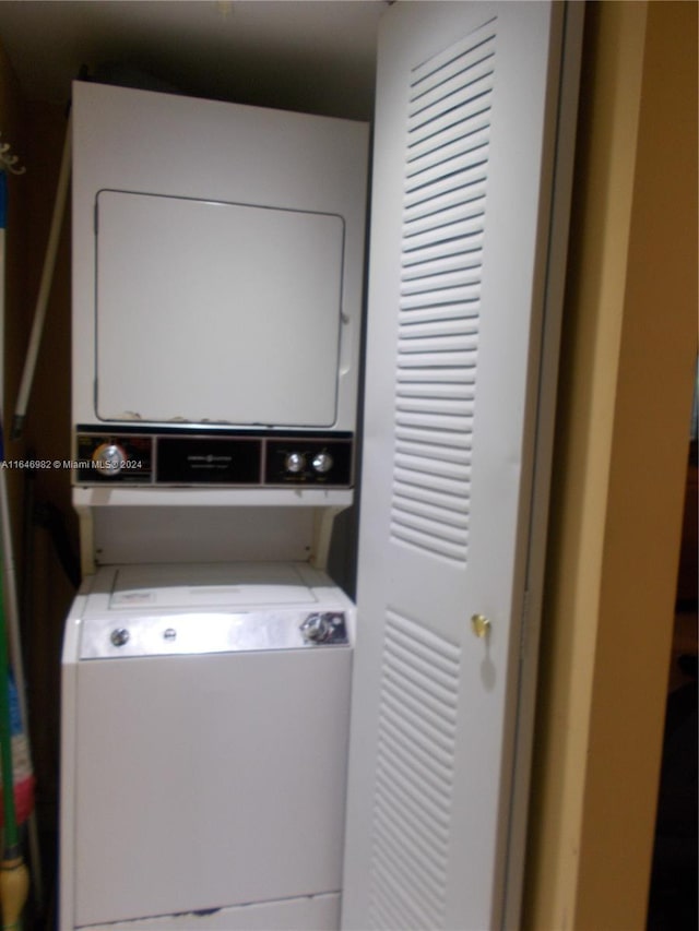 washroom featuring stacked washer and clothes dryer