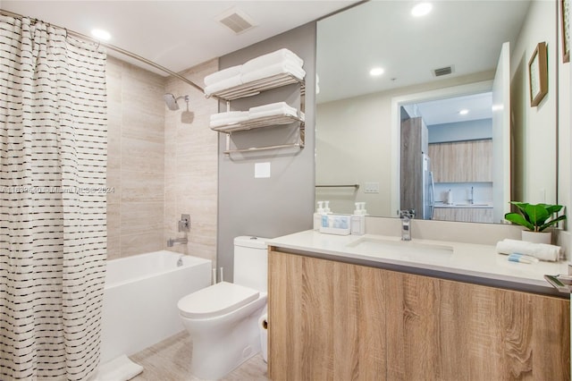 full bathroom with tile patterned flooring, toilet, shower / tub combo with curtain, and vanity