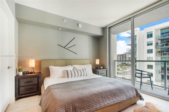 bedroom with floor to ceiling windows and access to exterior