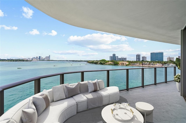 balcony featuring a water view and an outdoor hangout area