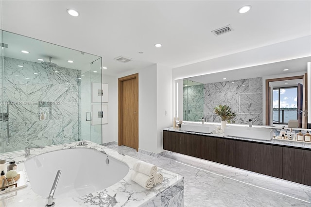 bathroom with vanity and independent shower and bath