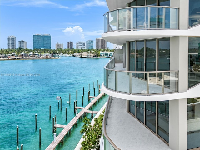 exterior space with a water view and a dock