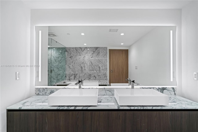 bathroom featuring backsplash, vanity, and an enclosed shower