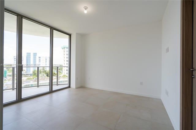 unfurnished room with expansive windows