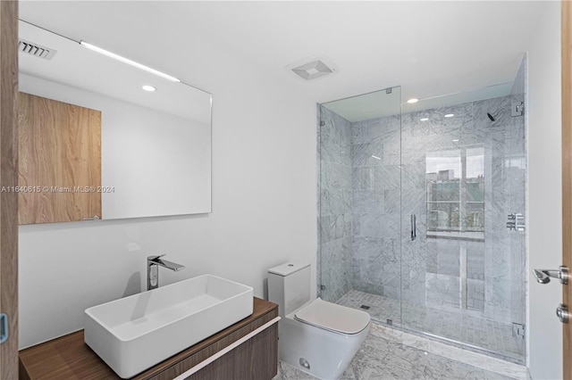 bathroom featuring vanity, an enclosed shower, and toilet