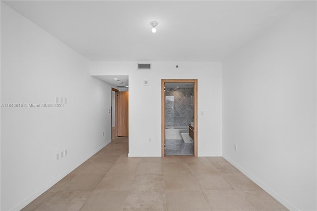 spare room featuring light tile patterned flooring