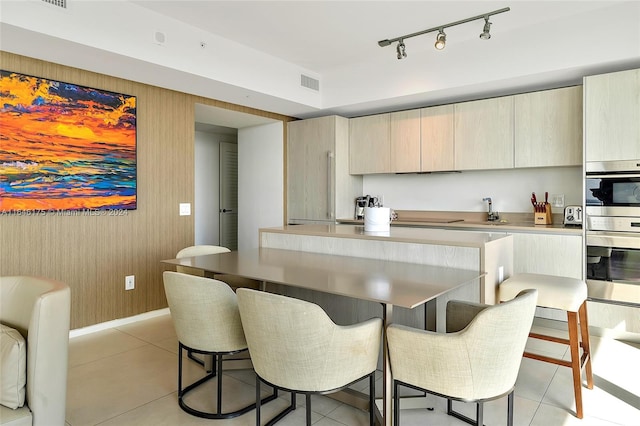 kitchen featuring light tile patterned floors, track lighting, and light brown cabinets