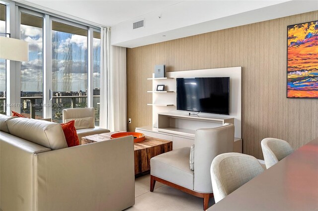 living room featuring a wealth of natural light and a wall of windows