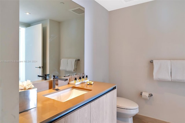 bathroom with toilet and vanity