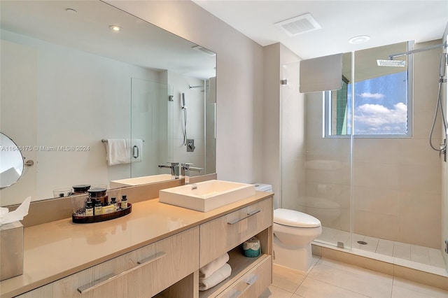 bathroom with toilet, vanity, walk in shower, and tile patterned floors