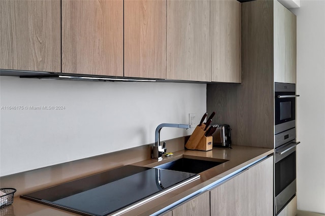 kitchen with sink and light brown cabinetry